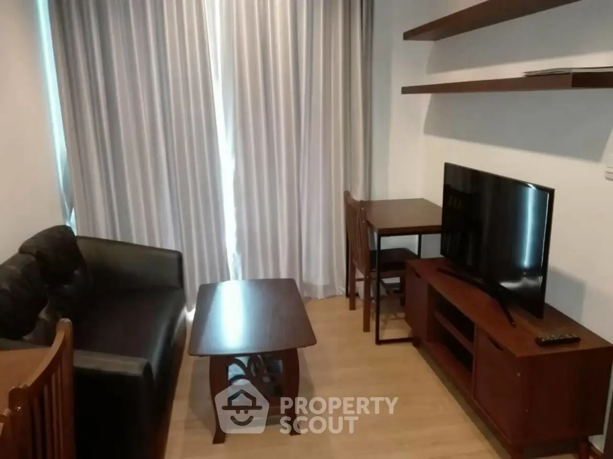 Cozy living room with modern furniture and TV setup, perfect for relaxation.