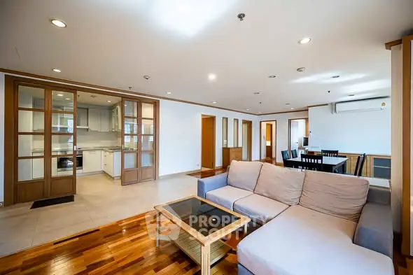 Spacious open-plan living room with modern kitchen and dining area.