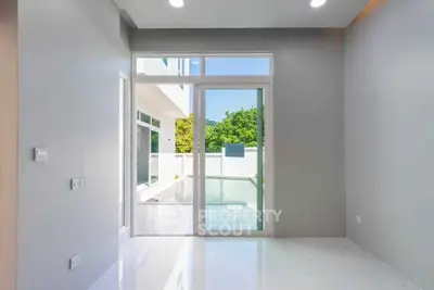Modern interior with sliding glass doors leading to a bright outdoor area