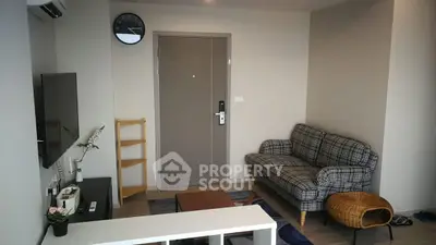 Cozy living room with modern decor and plaid sofa, perfect for relaxation.