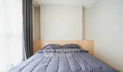 Modern minimalist bedroom with cozy bedding and natural light