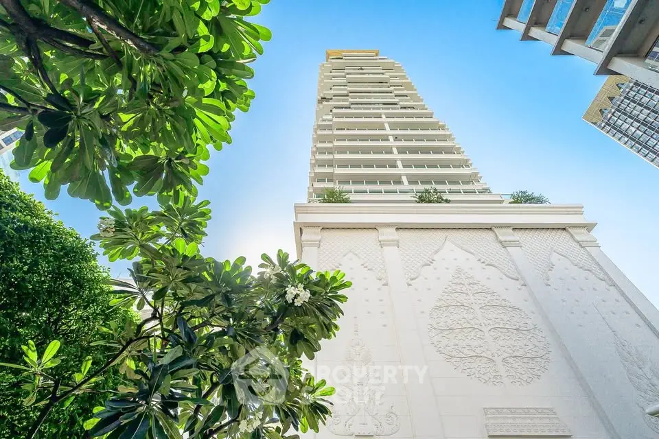 Stunning architectural building with lush greenery and clear blue sky
