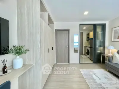 Modern living room with sleek design and integrated laundry area