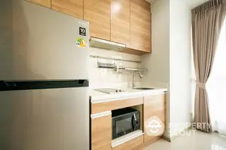 Modern kitchen with sleek wooden cabinets and stainless steel appliances