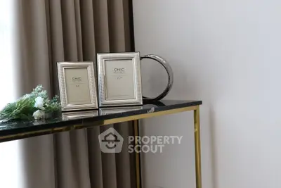 Elegant interior decor with framed art and modern console table in stylish living room.