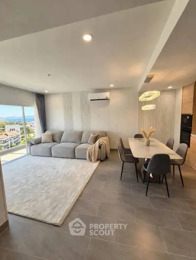 Spacious modern living room with dining area and scenic view