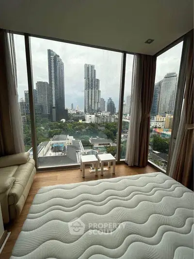 Luxurious bedroom with panoramic city view from floor-to-ceiling windows in modern high-rise apartment.