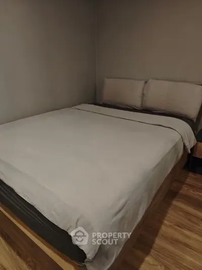 Cozy bedroom with modern design and wooden flooring, perfect for relaxation.