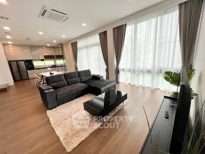 Spacious modern living room with large windows and stylish furniture