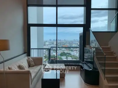 Modern living room with stunning city view and stylish staircase