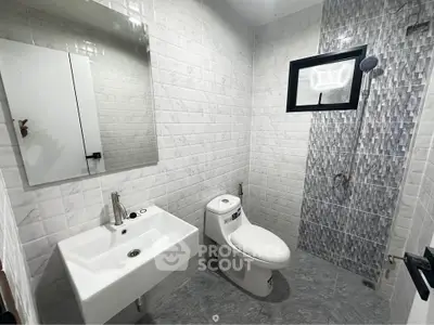 Modern bathroom with sleek white tiles and contemporary fixtures
