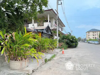 Charming residential street view with lush greenery and modern architecture