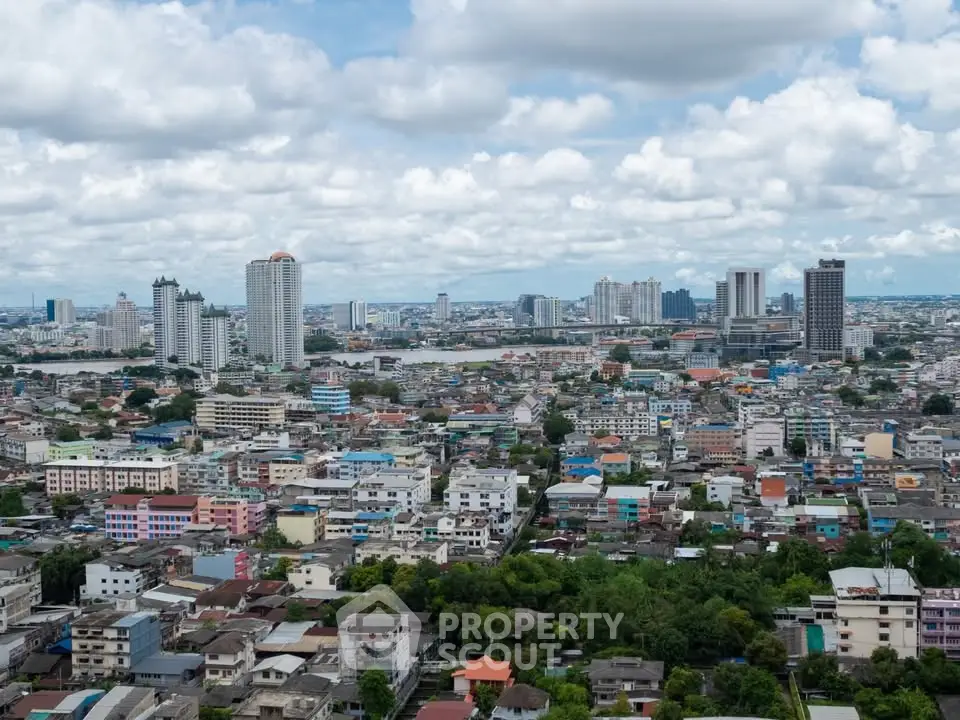 Stunning cityscape view showcasing urban skyline and residential buildings under a cloudy sky.