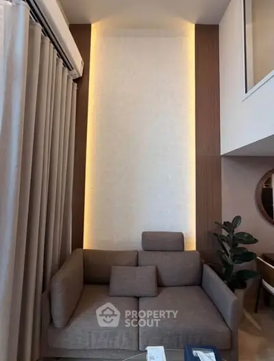 Modern living room with stylish sofa and elegant lighting in a contemporary apartment.