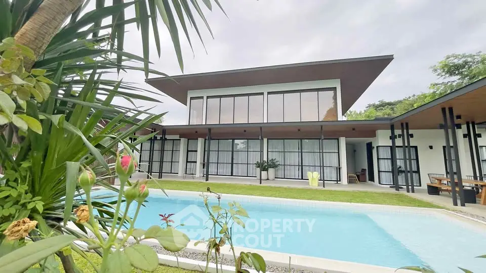Stunning modern villa with pool and lush garden, perfect for luxury living.