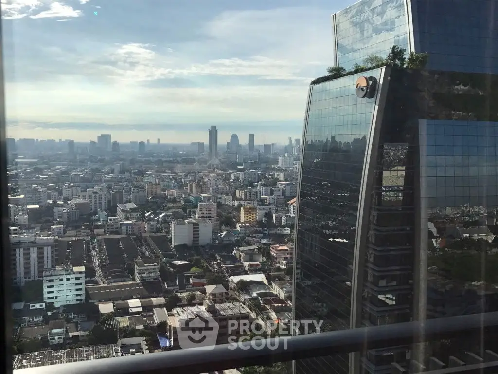Stunning cityscape view from a high-rise building balcony, showcasing urban skyline.