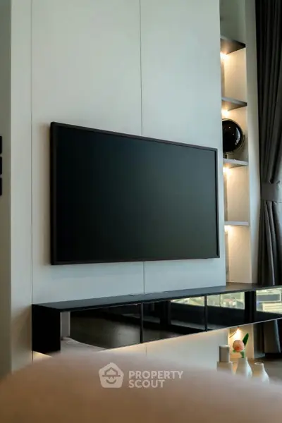 Modern living room with sleek TV setup and stylish shelving, perfect for contemporary urban living.