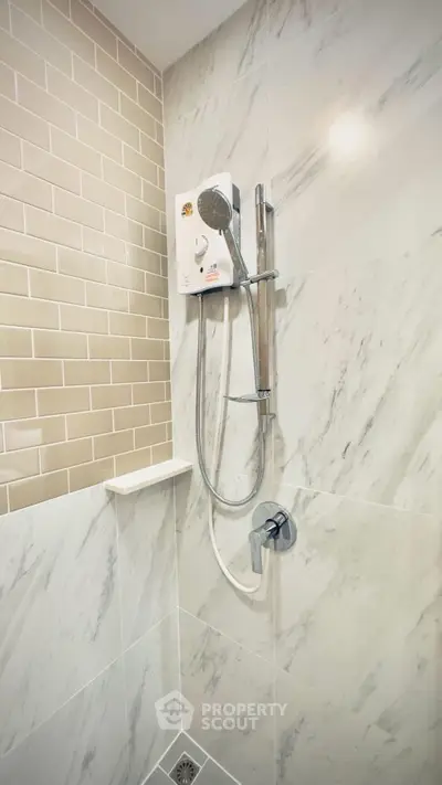 Modern bathroom with sleek shower and marble tiles