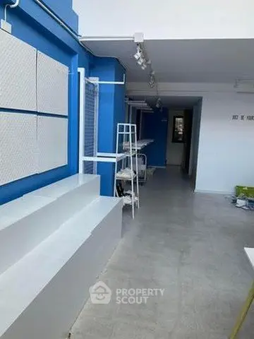 Modern interior space with blue and white decor, featuring sleek shelves and steps.