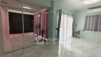 Spacious modern living room with marble flooring and large windows.