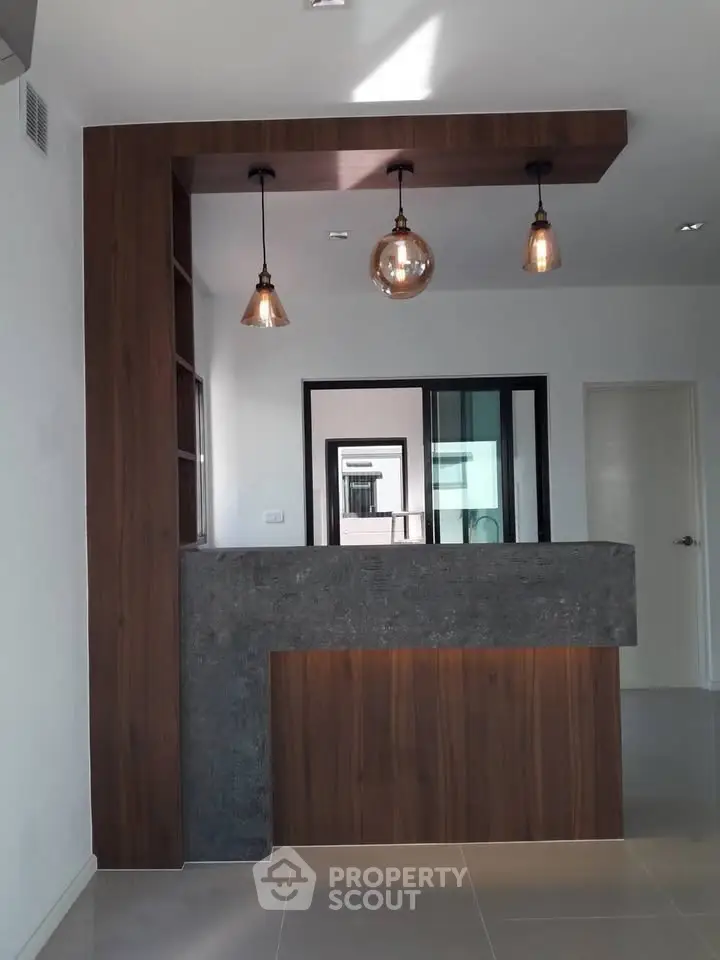 Modern interior with stylish lighting and wooden accents in a contemporary home setting.