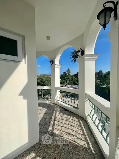 Charming balcony with arched design and scenic view, perfect for relaxation and enjoying the outdoors.