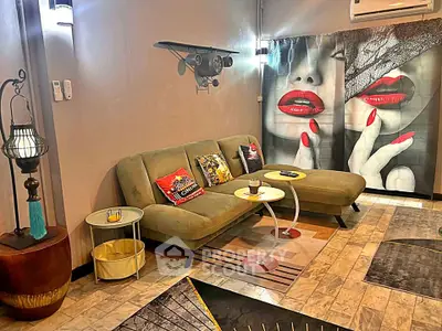 Stylish living room with modern decor and unique wall art, featuring a cozy sofa and chic lighting.