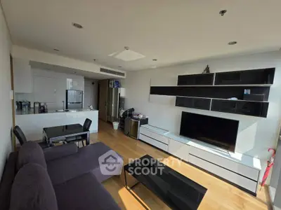 Modern living room with sleek furniture and open kitchen layout
