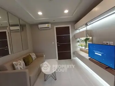 Modern living room with sleek furniture and wall-mounted TV, showcasing contemporary interior design.