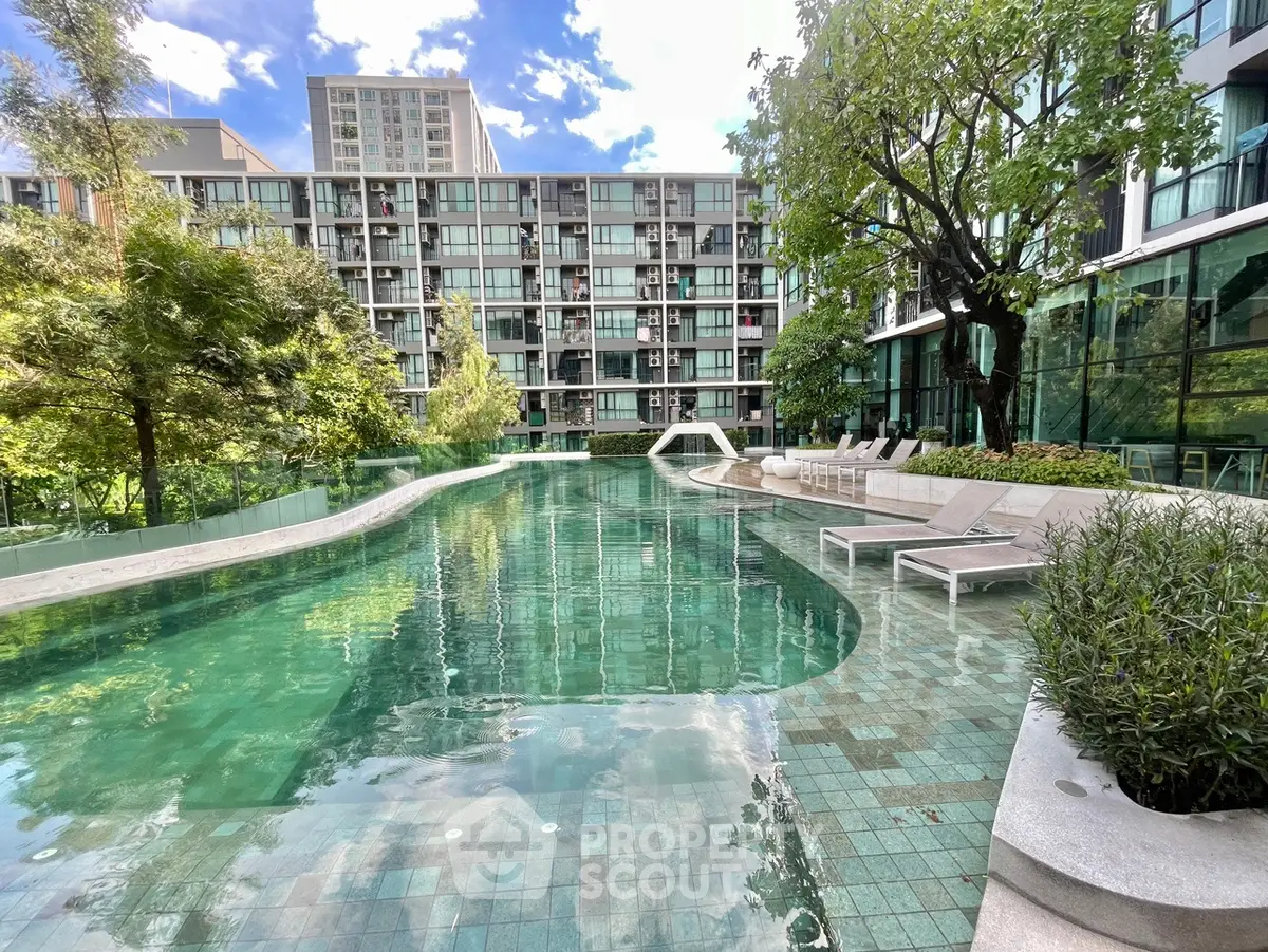 Luxurious residential pool area with modern design and lush greenery, perfect for relaxation and leisure.