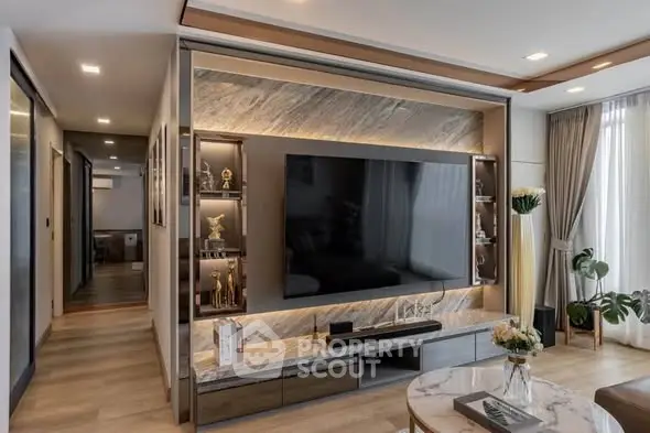 Luxurious modern living room with large TV and elegant decor