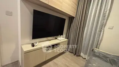 Modern living room with sleek TV setup and stylish cabinetry