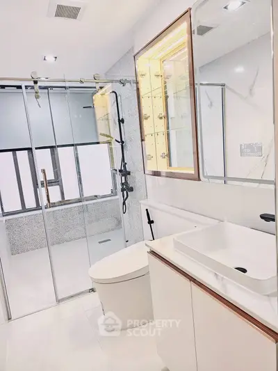 Modern bathroom with sleek fixtures and glass shower enclosure