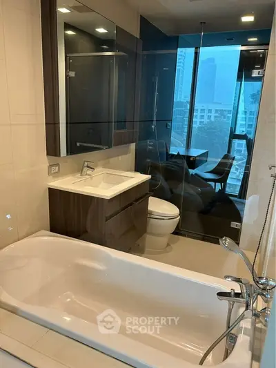 Modern bathroom with city view, glass shower, and sleek fixtures