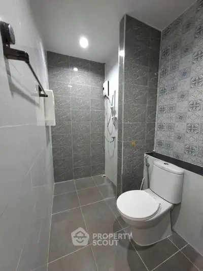 Modern bathroom with sleek gray tiles and stylish shower area