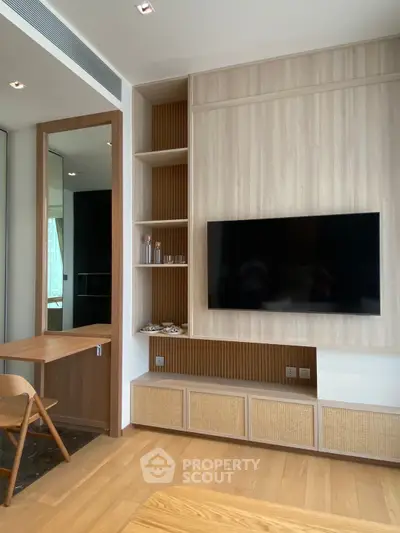 Modern living room with sleek TV setup and stylish wooden decor