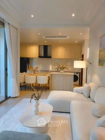 Modern open-plan living room with elegant kitchen and cozy seating area