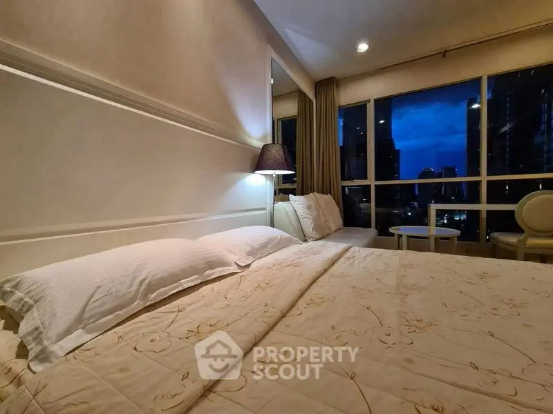 Luxurious bedroom with city view and elegant decor, perfect for urban living.