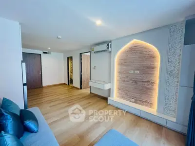 Spacious modern living room with elegant wood flooring and stylish accent wall
