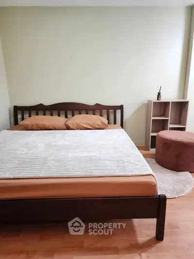 Cozy bedroom with wooden bed frame and modern decor