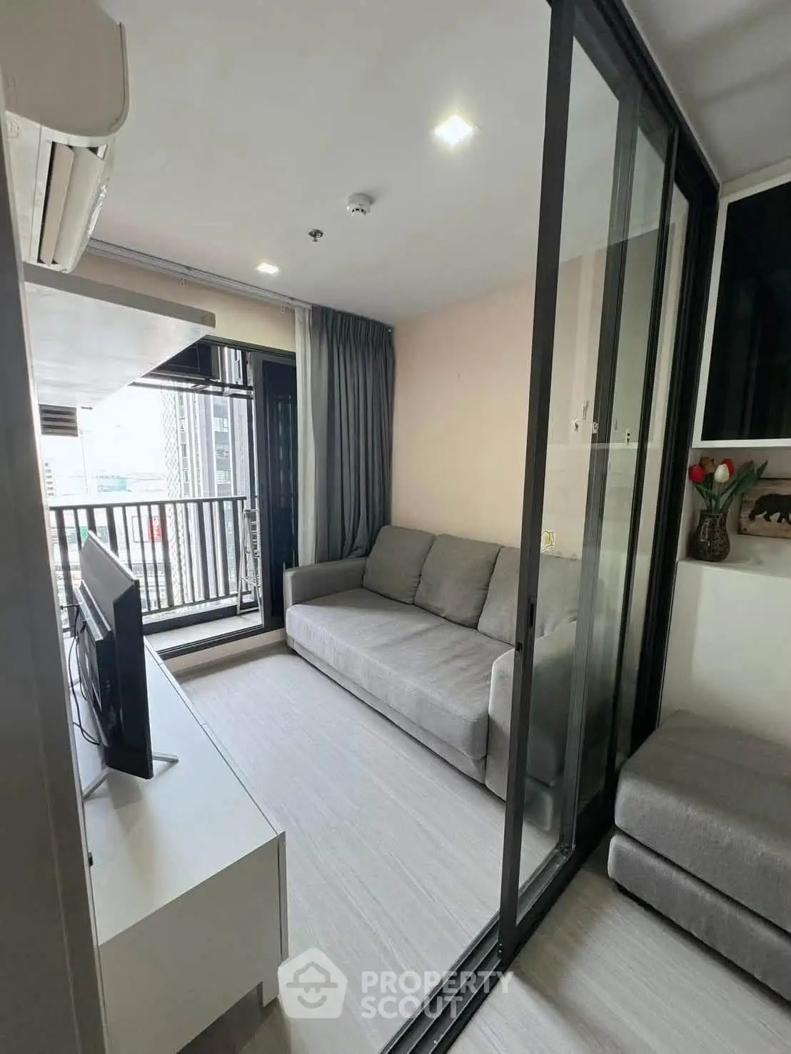 Modern living room with sliding glass doors and city view balcony