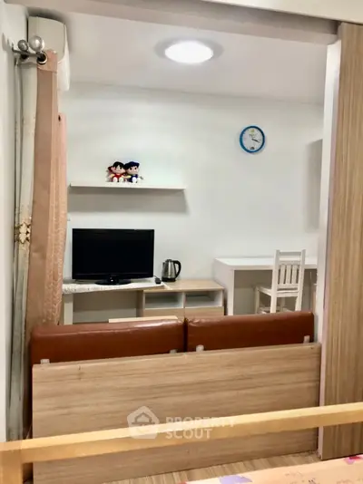 Cozy living room with TV, desk, and modern decor