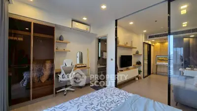Modern bedroom with study area and sleek design, featuring a cozy bed and stylish decor.