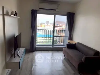 Modern living room with city view, featuring sleek furniture and large window for natural light.