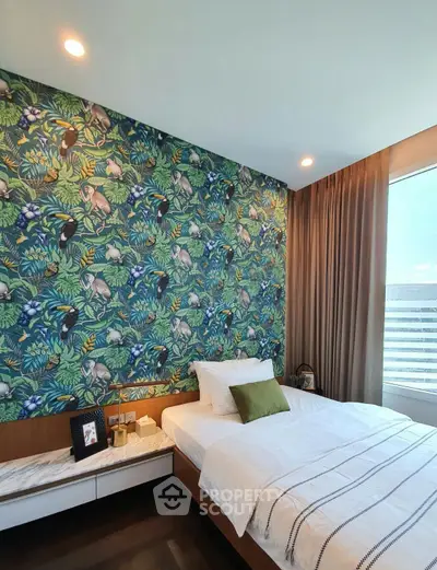 Stylish bedroom with vibrant jungle-themed wallpaper and modern decor