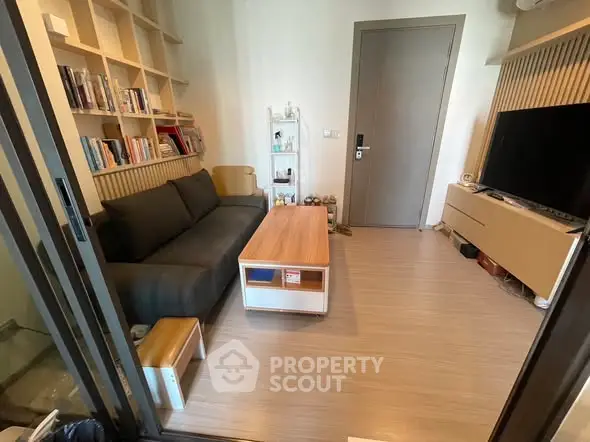 Modern living room with sleek furniture and built-in shelving