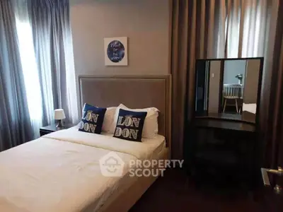 Cozy bedroom with stylish decor and natural light, perfect for relaxation.