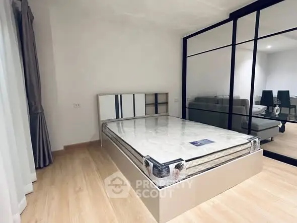 Modern bedroom with glass partition and minimalist design