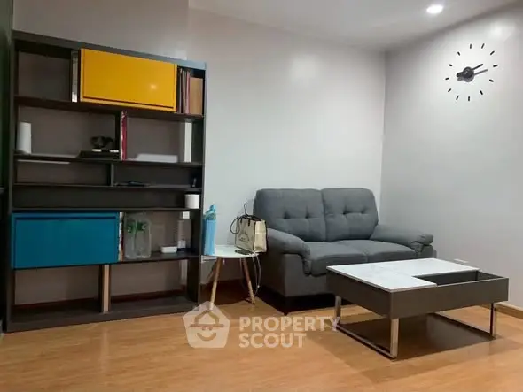 Modern living room with stylish shelving and comfortable sofa, perfect for relaxation and entertainment.