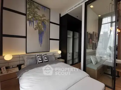 Modern bedroom with stylish decor and glass partition leading to a cozy seating area.
